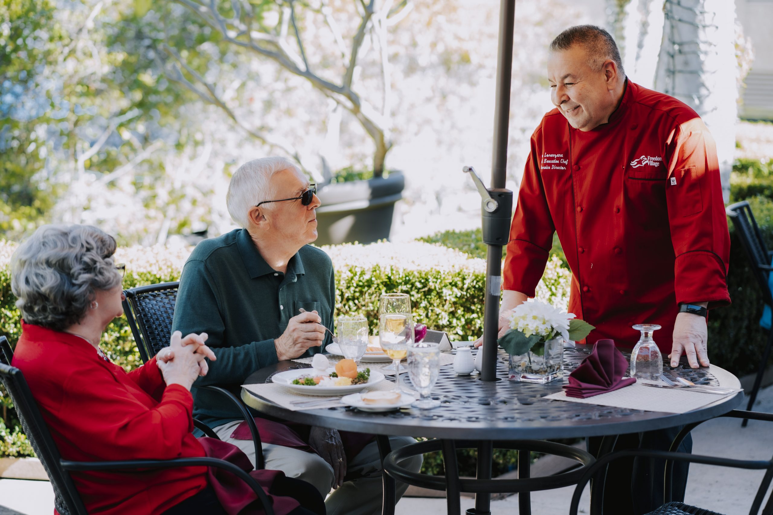 Chef Chatting Horiz1 three senior women laughing while sharing a meal